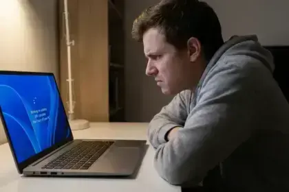 Windows 11 update screen with loading spinner and user waiting anxiously.
